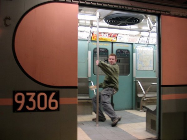 chris does a pole dance on a train from the '60s