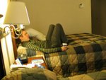 enjoying the comforts of a nice hotel room in the bed he had to share with chris